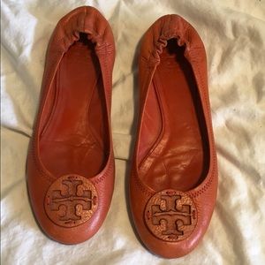 Orange Tory Burch flats.